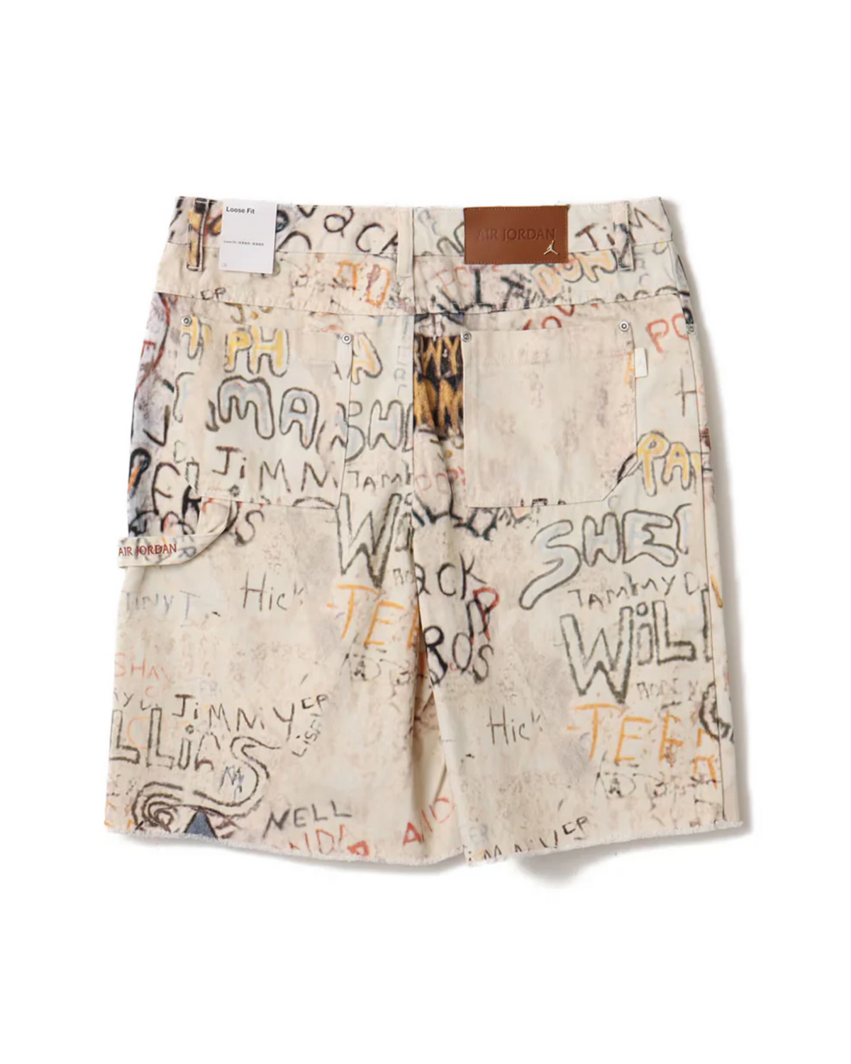 Jordan Air Jorts Printed -shortsit takaa, graffitiprintti, takataskut ja ruskea Air Jordan -nahkamerkki.